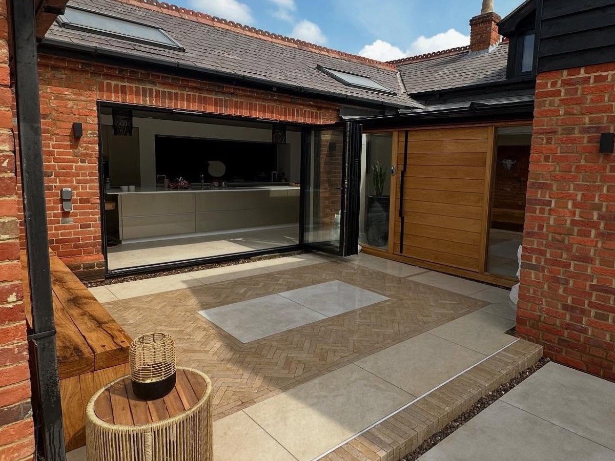 The same courtyard finished in smooth porcelain with a hardwood bench